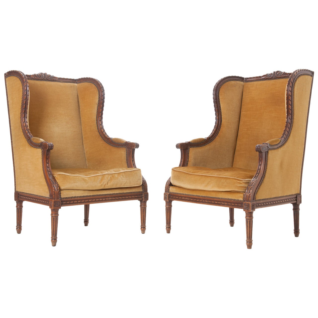 Pair of French 19th Century Carved Walnut Wingback Bergeres