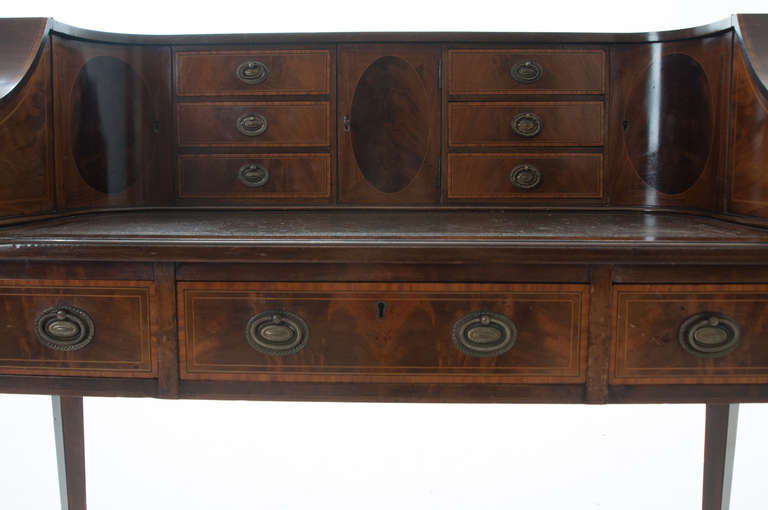 English mahogany, satinwood and ebony Carlton desk, mid-late 1800s. The rectilinear front with a 