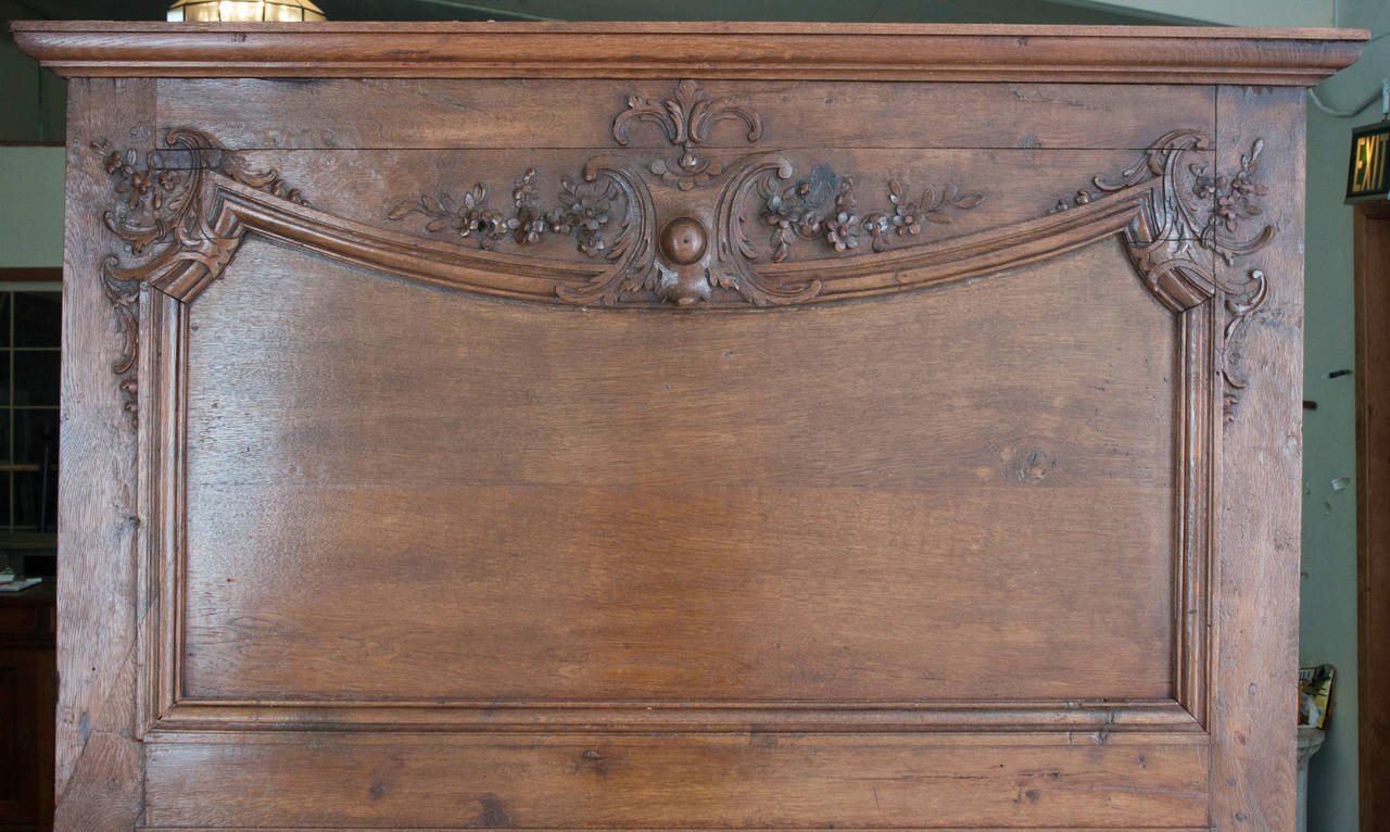 French large trumeau made in a simple design of dark oak with relief carvings of flowers.