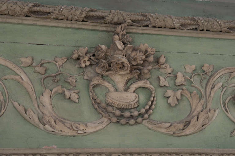 French painted and carved wood trumeau. The craftsmanship of this piece is outstanding. The crest above the mirror begins with twin swans holding strings of pearls in their beaks top with flowers, going into swirling designs with more swans, flowers