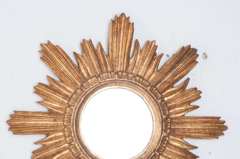 French small star burst mirror of carved gilt-wood, holding new mirror. Circa 1890's or earlier

Thank you for your interest in our antiques. To view our full store online, visit www.firesideantiques.com