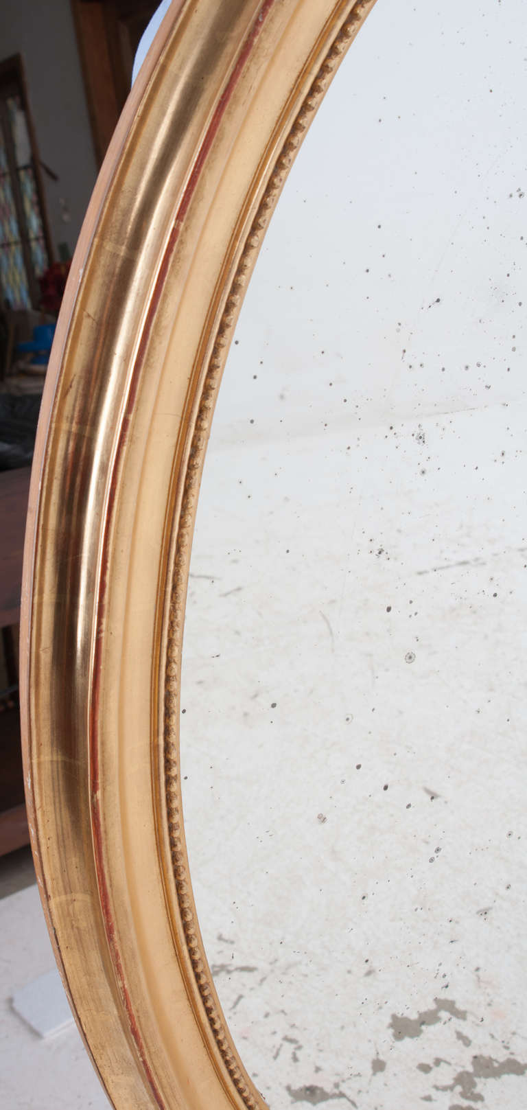French gold gilt oval mirror with old mirror glass. Stunning!