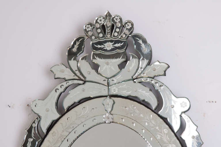 Venetian oval mirror has a delicately etched and layered frame with iconic crown at the top. The whole is  held together with cut glass flowers, the back is supported with black painted wood. made in the late 1800's. 

Thank you for your interest