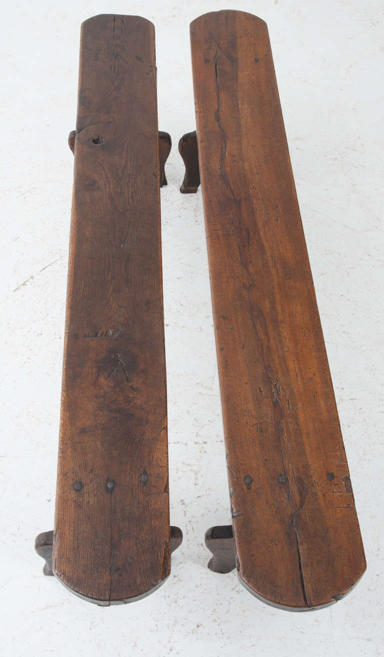 Great pair of oak benches all handmade construction with a rich patina and fresh French polish, the legs are trestle looking with an interesting carved design. 1850's
The benches are not exact, the measure slightly different. 
16