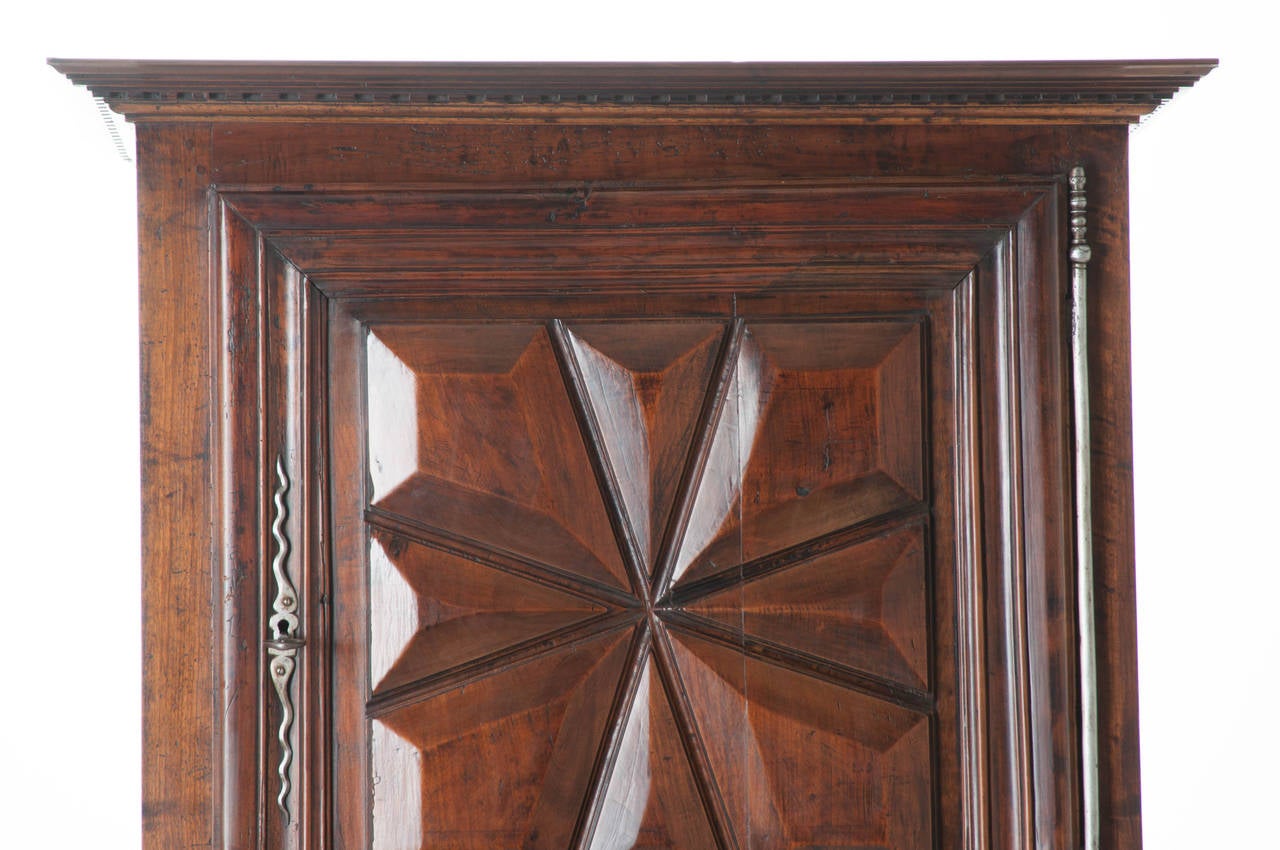 French hand carved mahogany Homme debout or cupboard in the Louis XIII fashion. The detail and thoughtful carvings make this a statement! The doors are thick mahogany with gem, cut panels. All steel original hardware are handmade and impressive with
