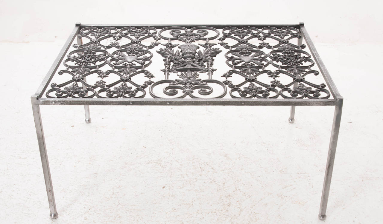 A stunning religious iron grill from a church has been recently made into a custom coffee table. The grill has been polished and cleaned to match the newly added table legs. Be sure to see the detail photos.