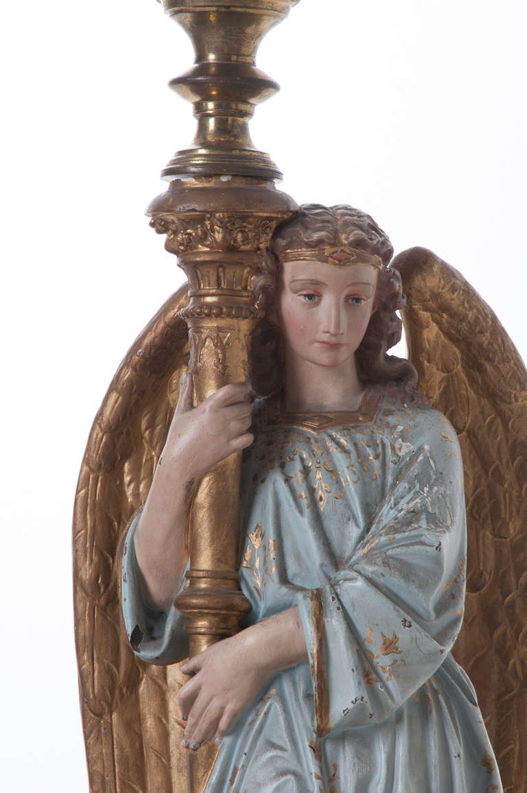 An outstanding pair of neoclassical angels with brass candlestick chandeliers, polychrome terracotta with plaster overlay and hand painted detailing, 1860s.