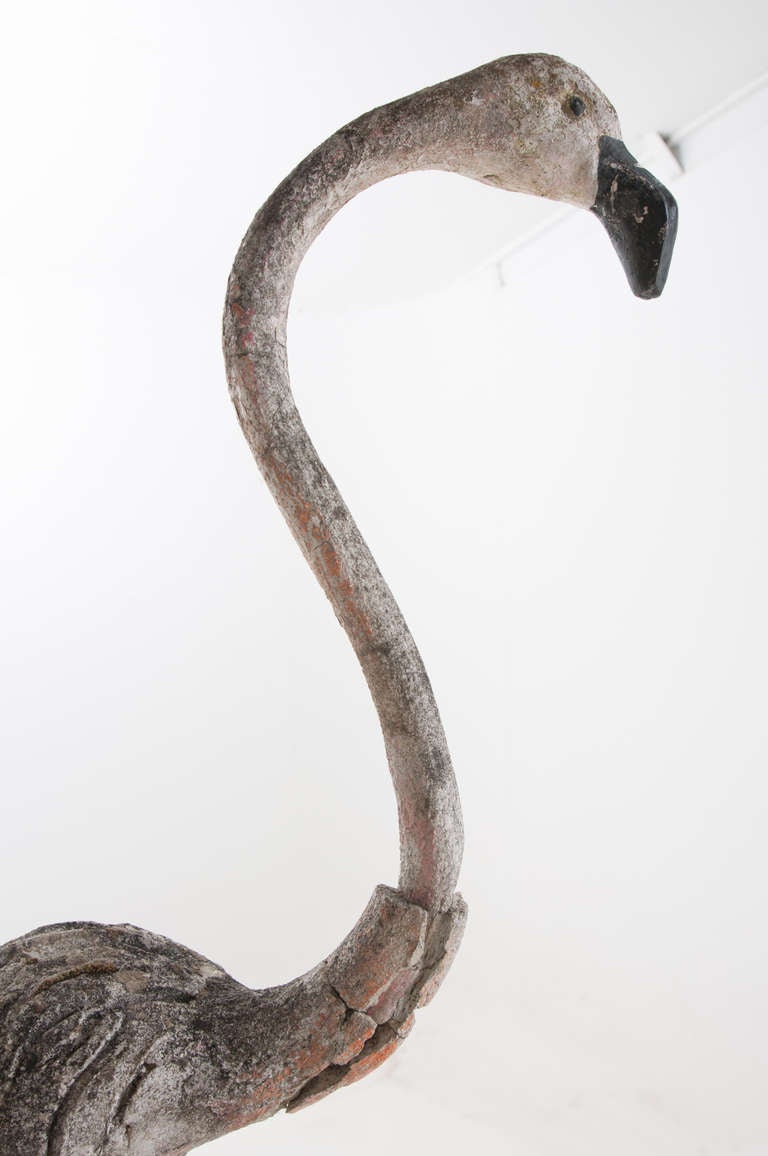 English made tall flamingo of metal with concrete. Seems the flamingo was once painted pink and has lost it's color over time in the sun. Missing part of his neck but still looking great. 

Thank you for your interest in our antiques. To view our