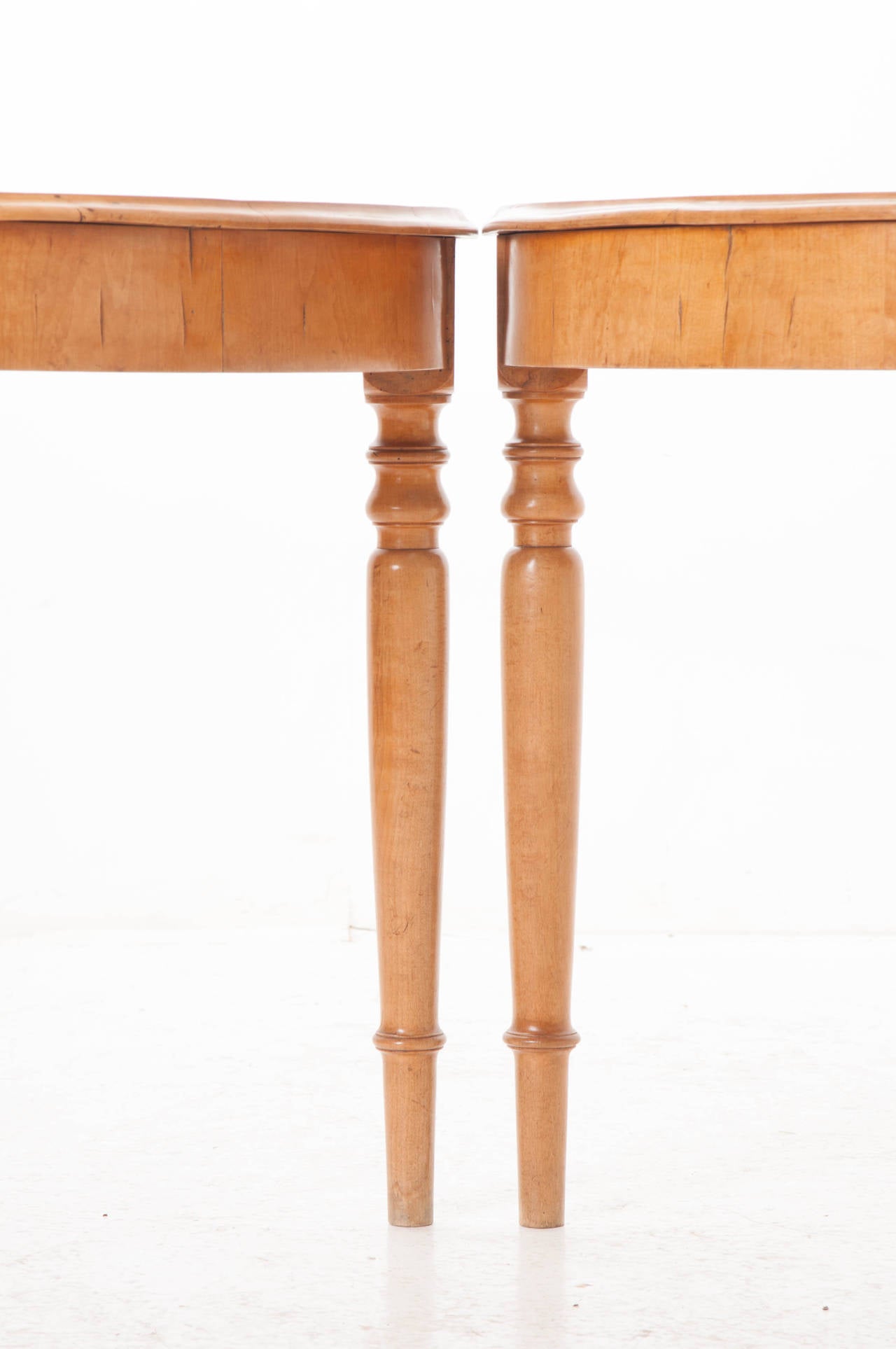 A great pair of Swedish demilune satin birch console tables. This fine pair can be used in many ways. Pull them together to make a small round table seating four or use as console tables in any room of your home. These consoles retain their