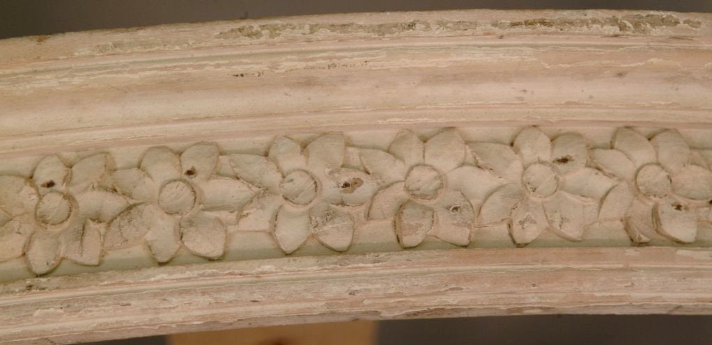 French painted and carved wood oval bed crown. Recessed floral motif.