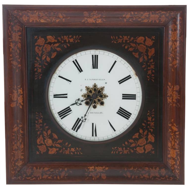 An impressive square wall clock by B.J. Vanderveken in Bruxelles, Belgium. The outer frame is made of rosewood with a very detailed inlay using fruit wood, the inlay continues on the interior frame with a round cut out for the clock face made of