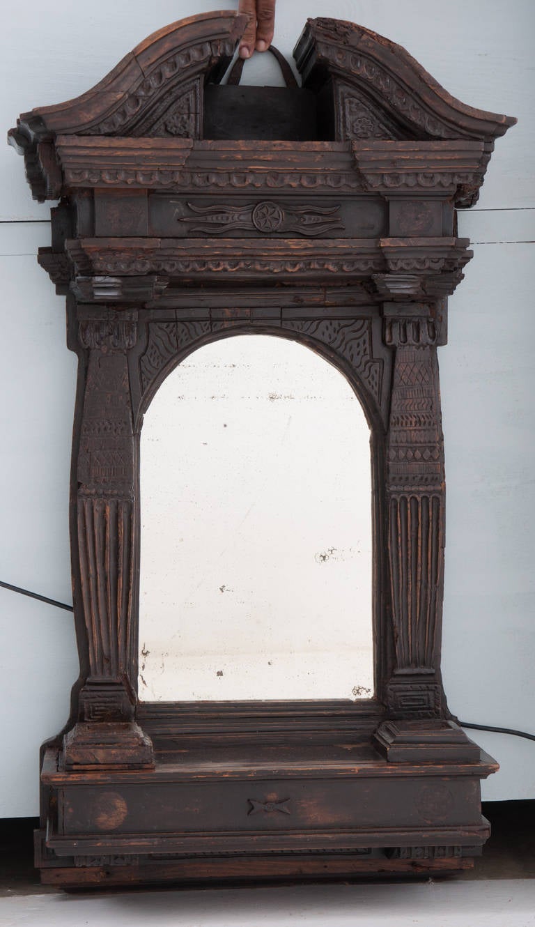 Wooden church alter with mirror is very old and from the late 1700s to early 1800s. Broken pediment top over hanging a domed mirror with a shelf, there must have been free standing decorative columns that sat in the squares of the bottom shelf which