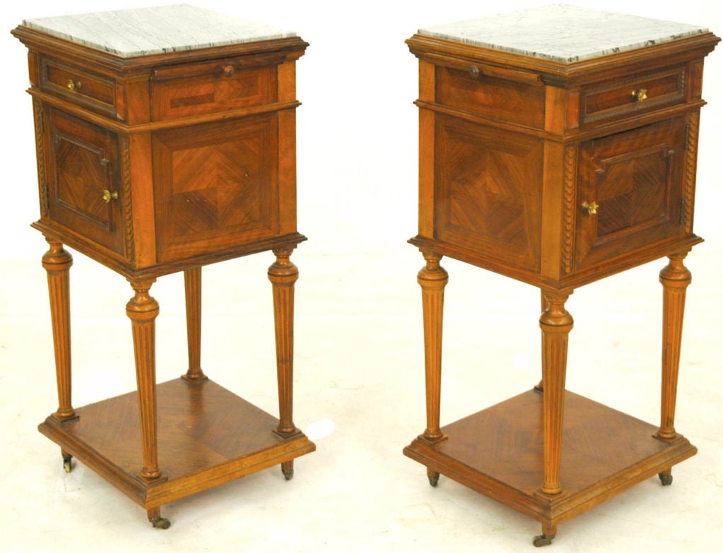 The nightstands are made of walnut and have detailed carvings. The top has one piece of marble inlaid, also has a drawer, pull out slide and cabinet.
