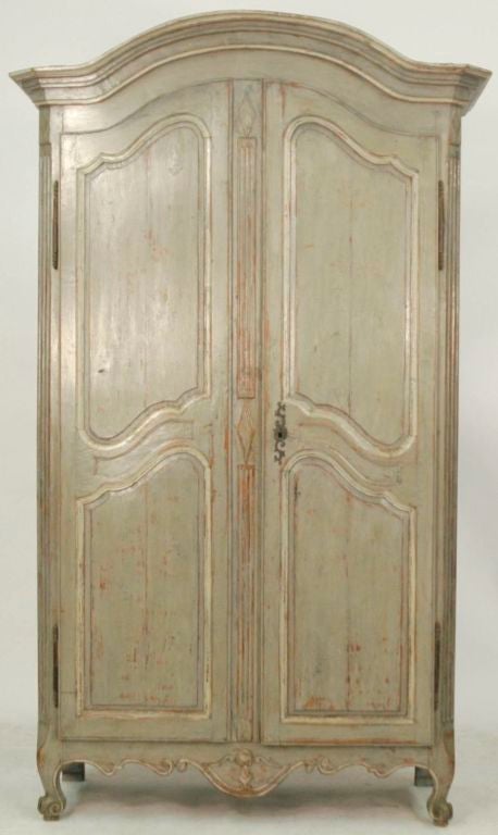 French wonderfully worn painted armoire from Bordeaux France. The armoire has paneled sides with a very rare diamond motif all sitting under a Chapeaude Gendarme crown and resting on escargot feet. Wonderfully lined with floral wallpaper, can be