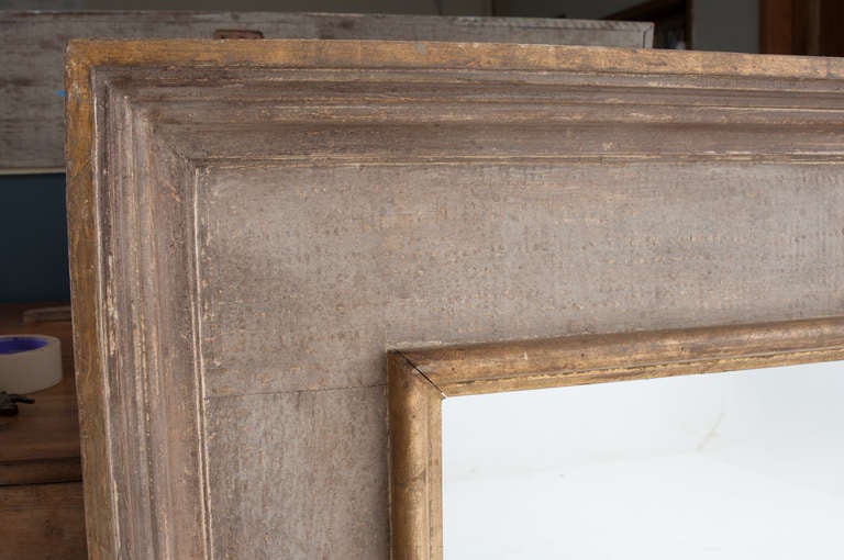 Painted symmetrical mirror frame made in Italy in the late 20th century with new mirror glass. 