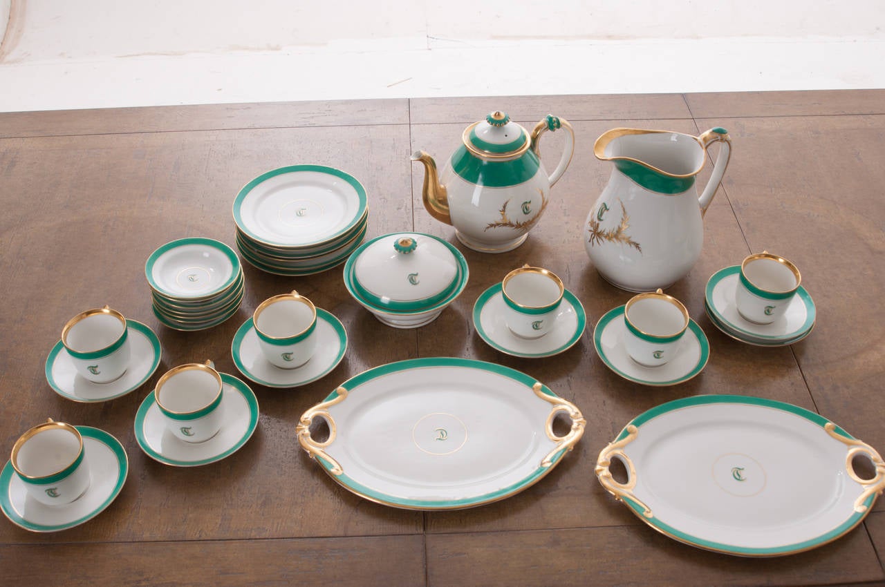 A stunning 33-piece set of Old Pairs white porcelain hand-painted and gold gilt dessert service. The letter 'T' adorns most of the pieces in this fine service from the mid-1800s.
One teapot.
One water pitcher.
One lidded and footed bowl.
Two