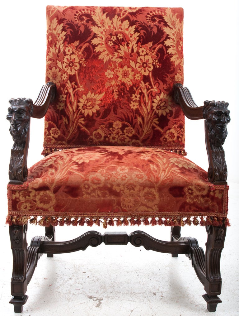 French Renaissance Revival Walnut Fauteuil, C. late 1800s.

The rectilinear padded back with square curved and fluted scrolled arms featuring grotesques joined to padded seat raised on square curved and fluted uprights joined by like scrolled “H”