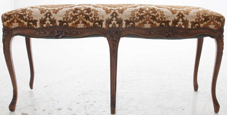 French Louis XV walnut carved bench with 6 long cabriole legs, stunning upholstery with nail head trim. 1880.