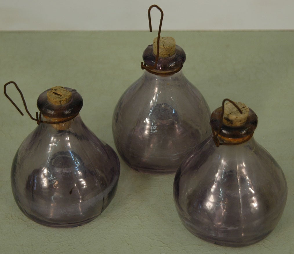Three Glass hanging fly catchers. Sugar water was put in the base which tempted the flys to fly in through the bottom and drown in the sweet liquid. Great conversation piece.