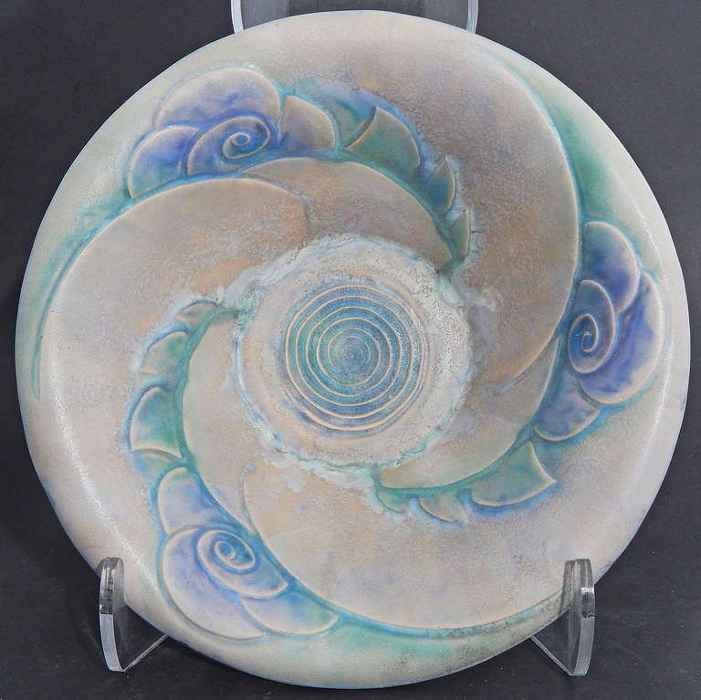 A classic example of Art Deco design, its swirling vortex embellished with stylized blossoms, this rare bowl was produced by Denby pottery in England.  The glazes are lovely -- a purplish gray contrasting with a muted green and hydrangea blue. 