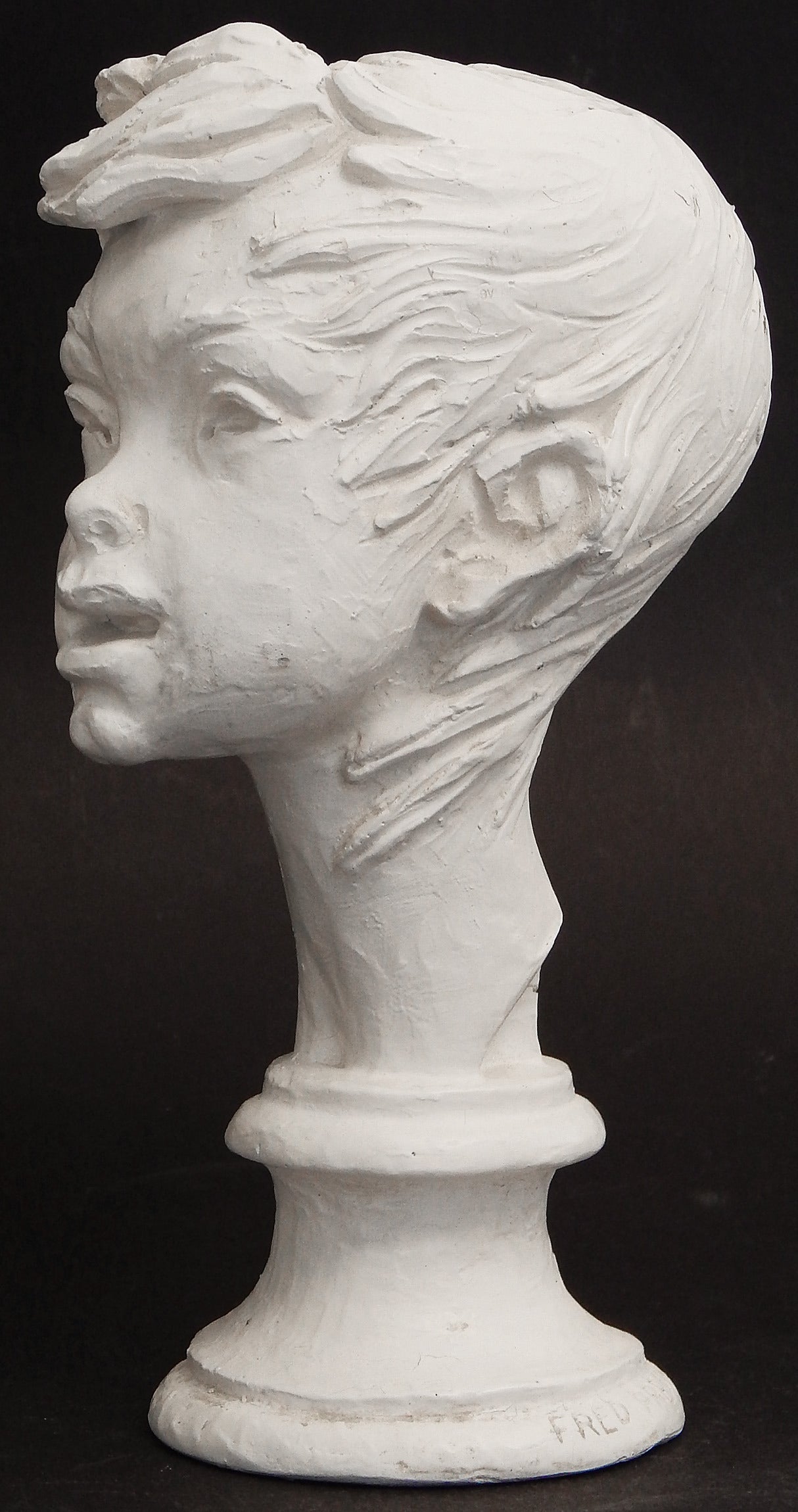 This depiction of a youthful figure, perhaps a street urchin from the alleys of New York, with his or her hair blowing wildly, is a rare or unique sculpture by Fred Press. Press was a kind of Renaissance Man in Mid-Century design, creating new