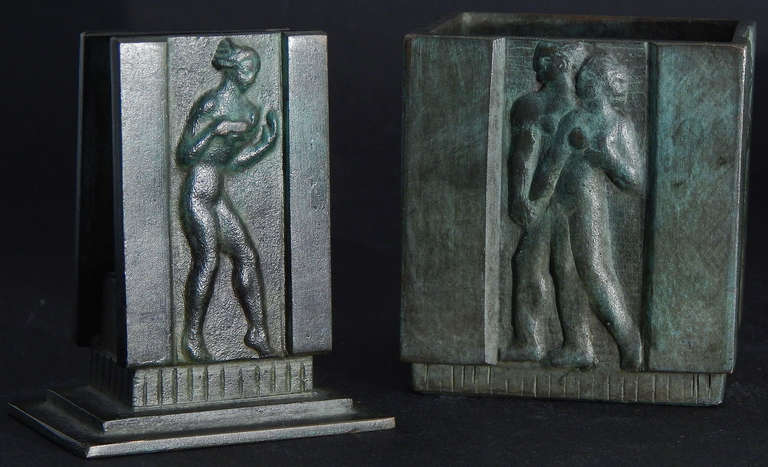 Sculpted and cast by the renowned GAB bronze foundry in Stockholm, this letter holder and pencil cup depict male and female nudes, singly or in couples, in bold, fine bas relief. The figures exhibit a dark patina contrasting with an old-copper