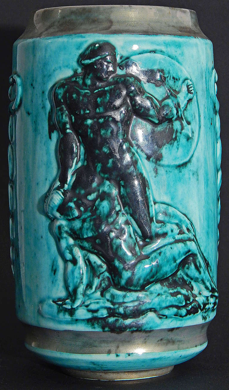 Created by one of France's great practitioners of Art Deco during its heyday in the 1920s and 1930s, this rare ceramic with relief sculpture by Jean Mayodon for the Sevres works pictures a nude male warrior triumphing over another nude warrior on