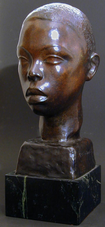 Exquisitely sculpted and cast in the 1940s by sculptor Eugen Gauss, this lovely bronze of a young African American man exhibits the stylized eyes and eyebrows beloved of artists in the Art Deco era, influenced by Etruscan and Greek sculpture.  Gauss