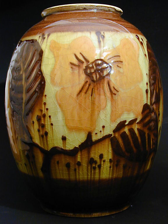 Brilliantly glazed in shades of puce, purplish brown and deep yellow, this magnificent vase is an important example of high Art Deco design, dating from 1945.  It was designed and glazed by Elizabeth Barrett, one of the master potters at Rookwood,