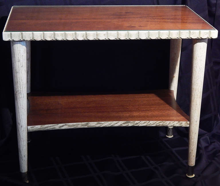Fine examples of late Art Deco furniture design, this pair of side tables feature mahogany tops, mahogany lower shelves, and cerused oak legs and edges.  The edges of each table top are also faceted; panels of glass are inset into each table top.
