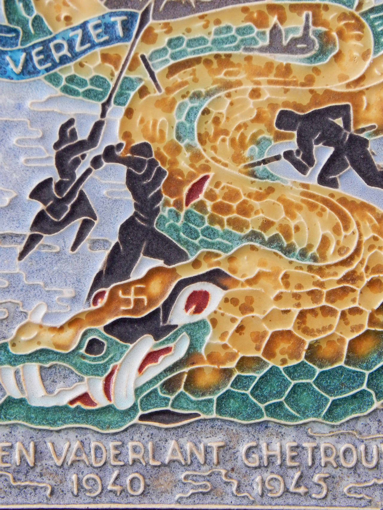 This rare and remarkable tile produced at the close of World War II in Delft, depicting the Nazi dragon being slayed by the Dutch people, is a superb example of Art Deco cloisonné tilework as well as politically-themed art. The dragon, with a