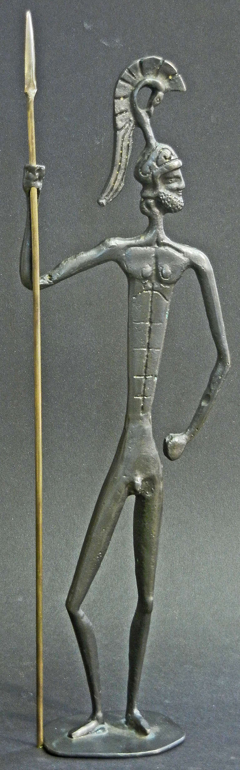 Showing the twin influences of pre-Classical Greek sculpture and Diego Giacometti, this attenuated bronze sculpture of a nude Greek soldier, complete with brass spear, was the mid-century equivalent of a Grand Tour bronze, collected by visitors and
