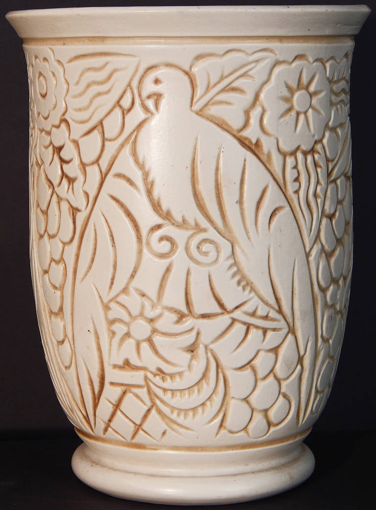 This very fine and rare Art Deco vase with deeply incised design, depicting tropical birds amidst a profusion of flowers and leaf forms, was designed by George Condé for Mougin Freres in Luneville, France. Condé was known for his designs for