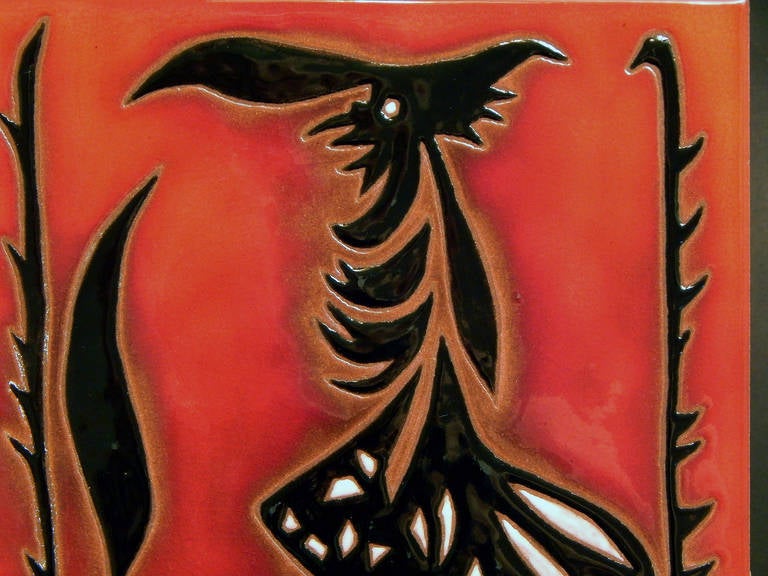 Created by Jean Lurçat, one of France's most prolific ceramic and tapestry designers, this rare tile in deep fiery red and black depicts one of Lurçat's fantastic man-birds. The artist started his career in the 1910s with the creation of tapestries
