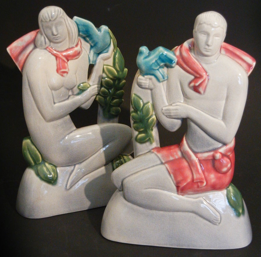 Probably sculpted by Geza De Vegh for Phoenix Pottery, this rare pair of very fine ceramic sculptures depict highly-stylized male and female figures, each holding doves. The gray, deep pink and blue-green glazes are gorgeous.