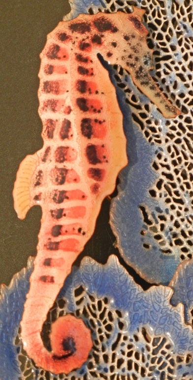 Dating from the heyday of enamel artistry after World War II, in an era that celebrated the teeming exoticism of undersea life, this wall sculpture is an especially fine example of its type.  The two seahorses, brilliantly finished in coral and