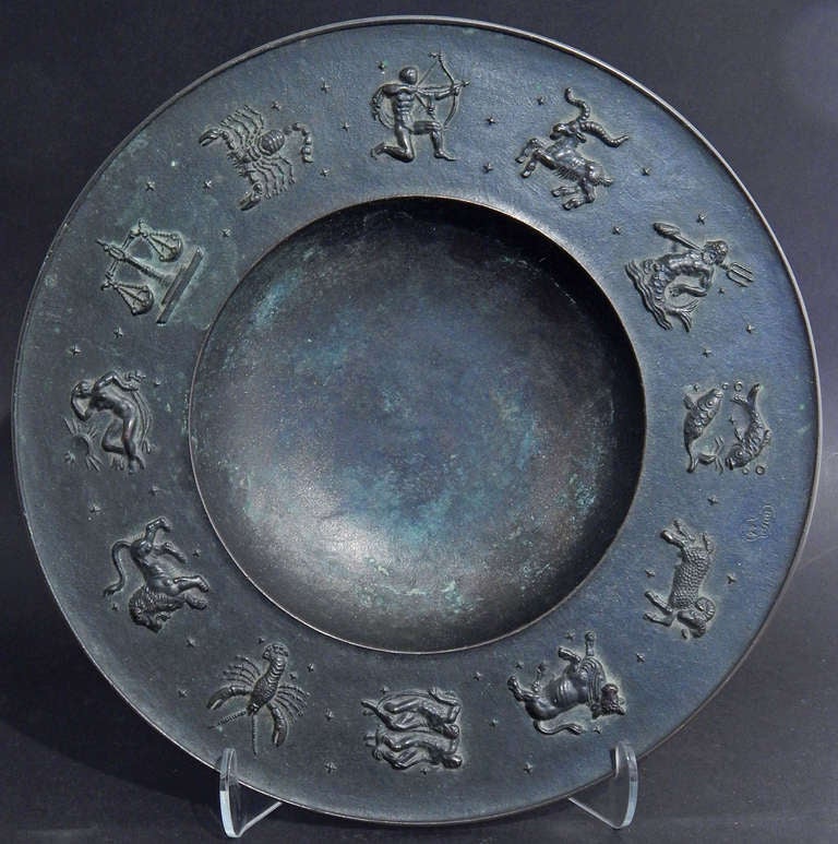 A superb example of 1940s Art Deco design, this bronze bowl features beautifully detailed Zodiac signs around its broad border, including nude figures representing Gemini, Sagittarius, Virgo and Aquarius (in this case represented by a figure of