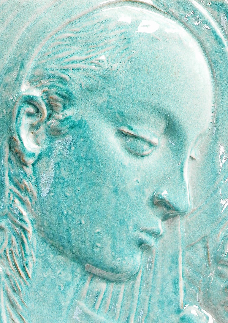This unique, sculpted tile by Lazzarini, an Italian sculptor in Syracuse, Sicily, captures some of the beauty and gravity of Renaissance nativity scenes.  Finished in a lovely, mid-century aqua glaze, the tile captures the heavy-lidded placidity of