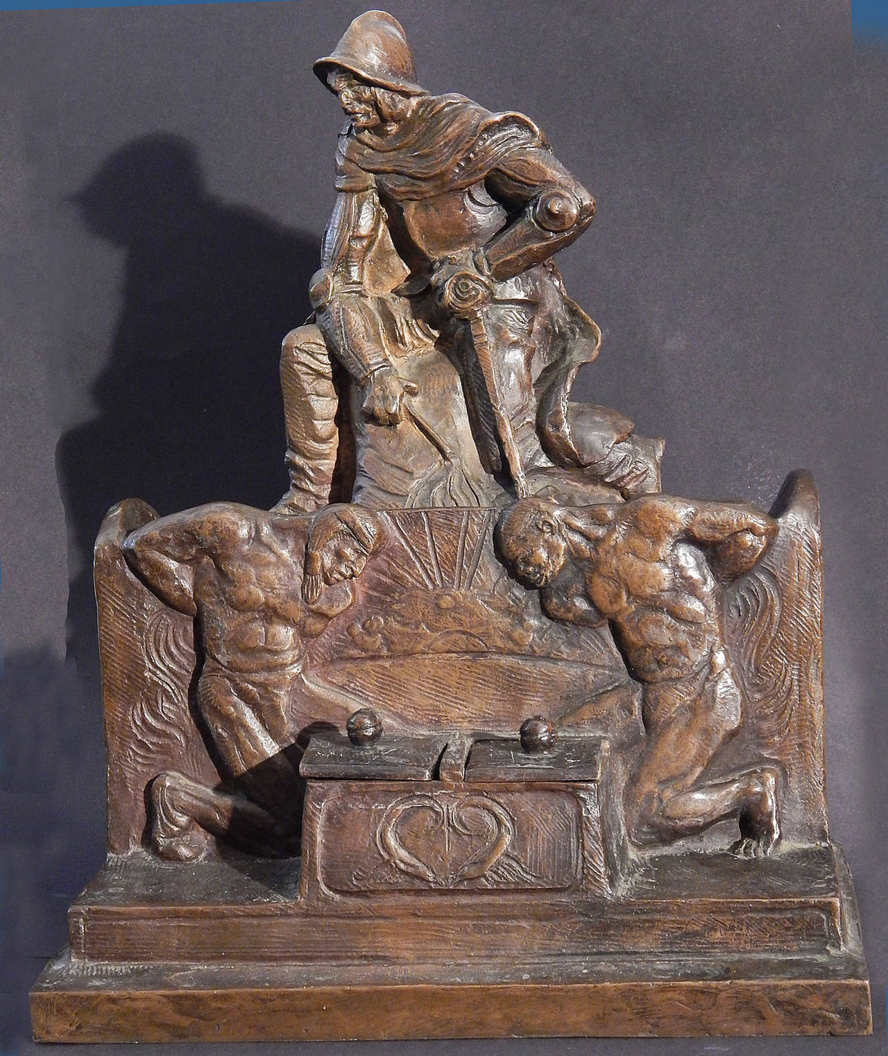 More of an indictment of the Spanish conquest of North America than a celebration, this quite extraordinary, large bronze inkwell depicts a Conquistador, holding sword and whip, seated above two bowed nude figures, clearly depicting Native and