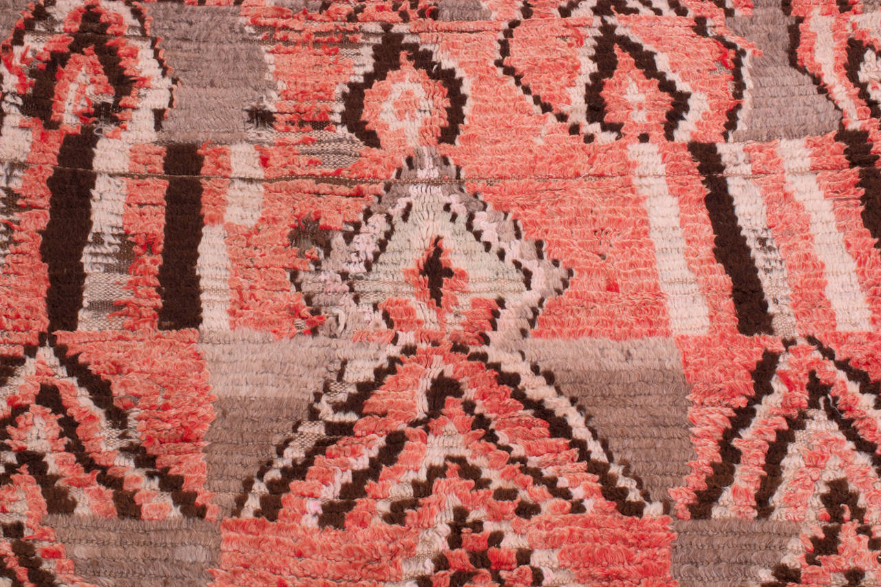 A fabulous old Berber carpet with organic graphics from the 1950s. This carpet is of a rare type and represents the archaic art of Morocco. The rug has some small holes and areas of wear and would be best suited as a wall hanging or low traffic area