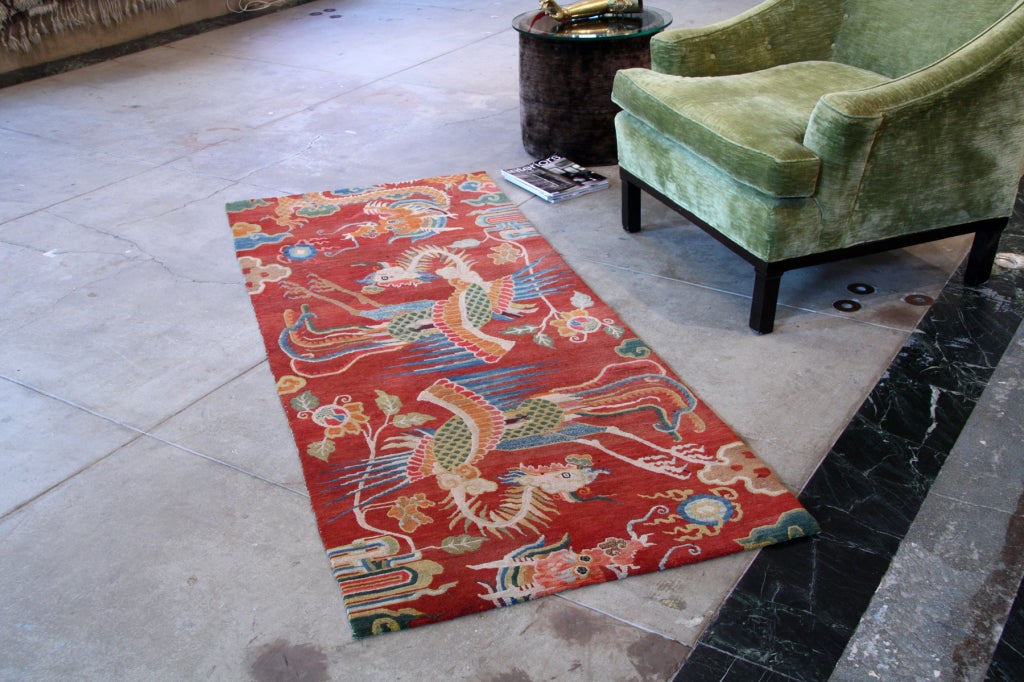 This fabulous, runner-like carpet displays the classic yin and yang symbols of Dragon and Phoenix. It is a smaller version of the ones that would often have graced the meditation room of a Tibetan monastery. It exhibits great colors and the very