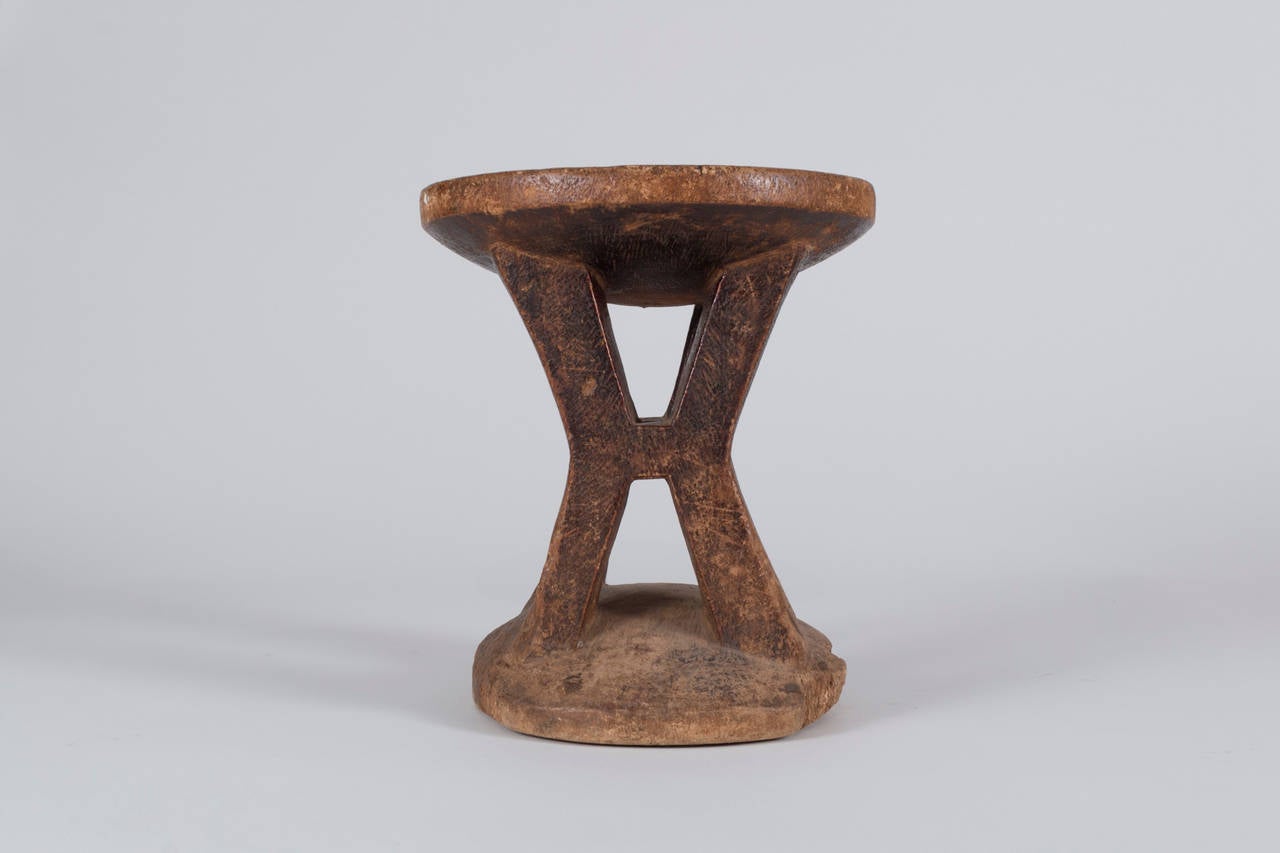 A hand-carved Igbo stool, hewn from one solid piece of wood.