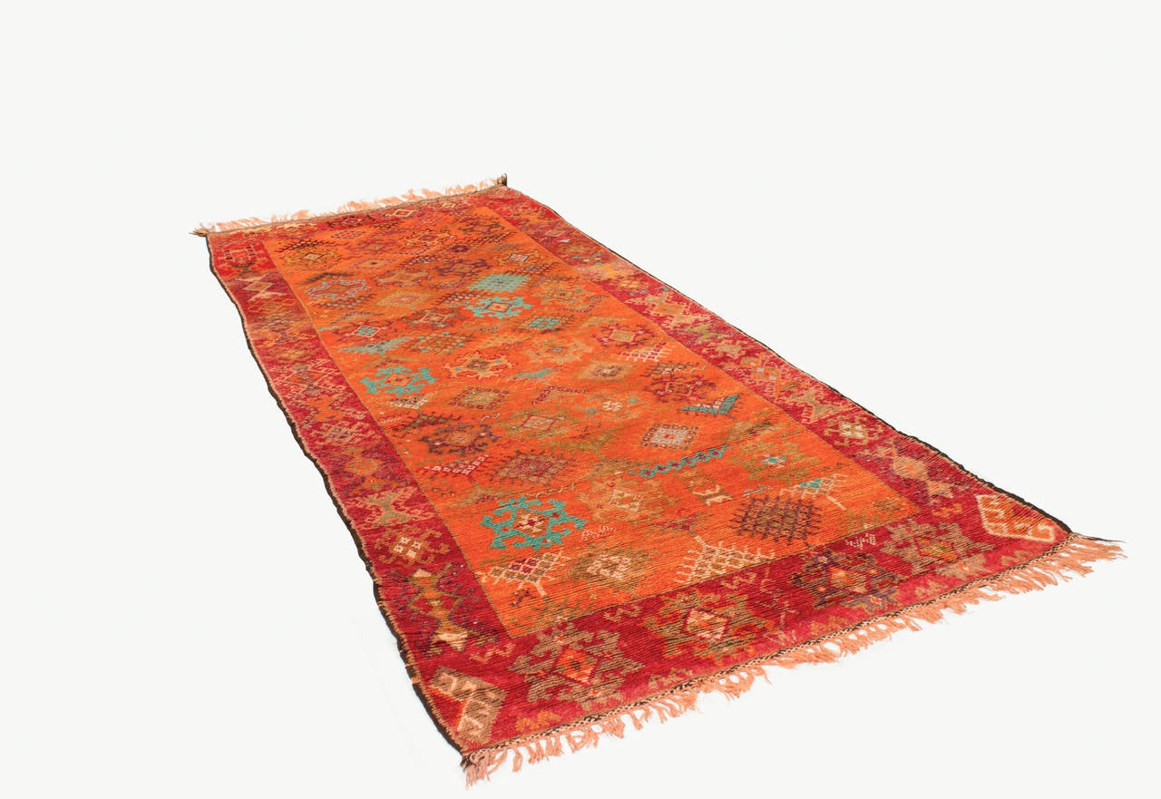 This bright traditional Berber carpet was handwoven by the Berber autochthones of North Africa, which is distinguishable by the distinct knot which is popular for areas with significant heavy use, such as offices. This Berber rug is woven in bright