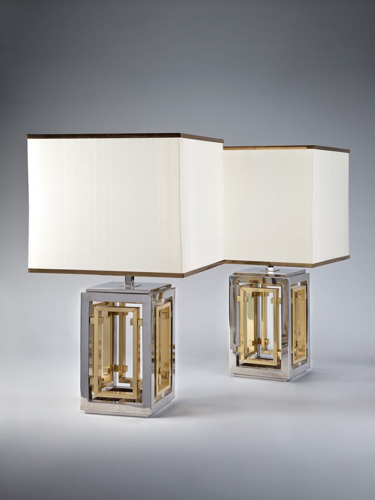 An Unusually formed pair of mid 1970s Italian Pavilion lamps fashioned from silvered metal, supporting an internal brass frame. By Romeo Rega.

Romeo Rega was a leading figure of contemporary Italian design. Alongside respective artists such as