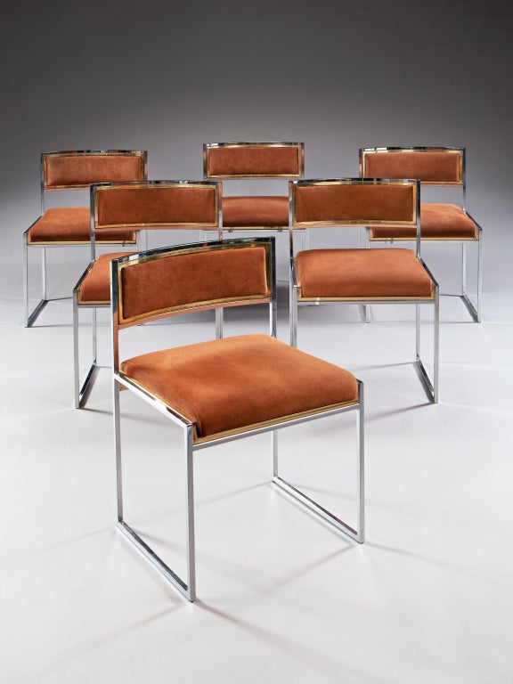 Each with a coved back and of geometric design, the steel frames are bordered with brass inner frames. Now upholstered in brown suede, with many of the chairs maintaining original manufacturing labels.