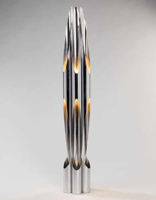 A highly unusual Italian mid century polished steel floor lamp in the form of a rocket with six up and down lights, by and stamped 'Reggiani Lampadari'.