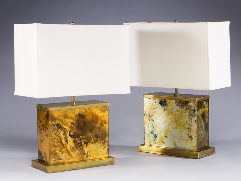 A pair of Italian mid-1960s lamps, taking the form of a glass rectangle with an unusual stippled surface decoration, standing on a rectangular brass plinth. Attributed to Romeo Rega.

Romeo Rega was a leading figure of contemporary Italian design.