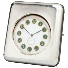 An Enamel Faced Travelling Clock in a Leather and Silver Case