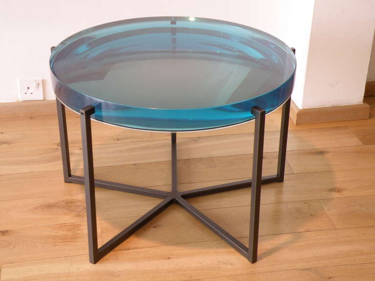 by McCollin Bryan, British
turquoise-tinted resin backed by an acrylic mirror, on black patinated metal legs
to order