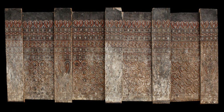 Large Saneh (architectural panel) from the exterior of a Torajan granary (Alang). Constructed of several heavy wood planks, the surface carved in low relief with traditional geometric auspicious patterns including the Pa'tangke lumu or 